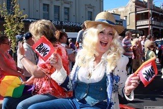 Maureen dressed as a cowgirl brandishing dual pistols